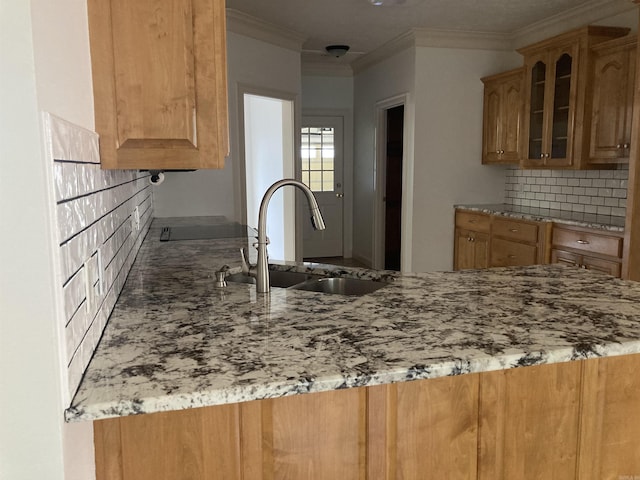 6 Donnie Cv, Greenbrier, AR 72058 - kitchen featuring a sink, light stone countertops, tasteful backsplash, glass insert cabinets, and crown molding