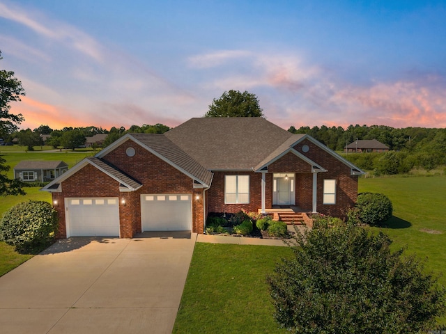 6 Donnie Cv, Greenbrier, AR 72058 - ranch-style house with brick siding, concrete driveway, a lawn, and an attached garage