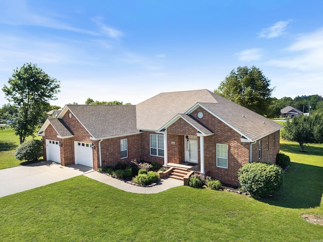 6 Donnie Cv, Greenbrier, AR 72058 - view of front of home featuring brick siding, a garage, a front yard, driveway, and roof with shingles