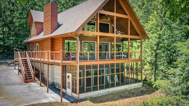 389 Tortoise Bay Rd, Higden, AR 72067 - rear view of house featuring a sunroom, a patio area, roof with shingles, and a deck