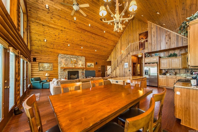 389 Tortoise Bay Rd, Higden, AR 72067 - dining area with high vaulted ceiling, wooden ceiling, stairs, a stone fireplace, and dark wood-type flooring