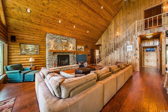 389 Tortoise Bay Rd, Higden, AR 72067 - living area featuring high vaulted ceiling, a stone fireplace, stairs, wooden ceiling, and hardwood / wood-style flooring