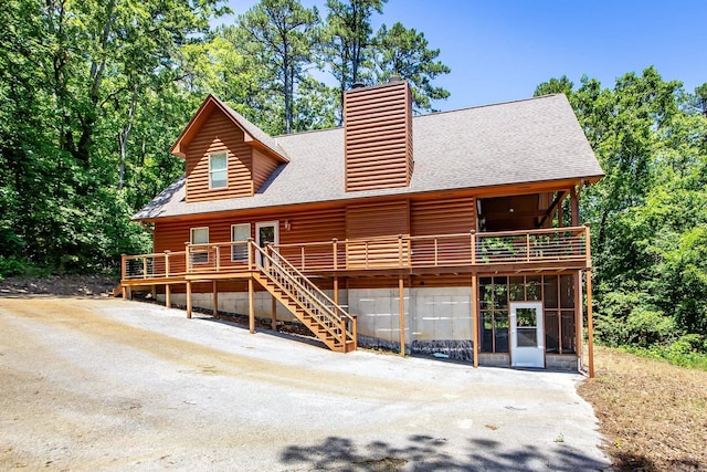 389 Tortoise Bay Rd, Higden, AR 72067 - back of house featuring a shingled roof, a chimney, a wooden deck, and a sunroom