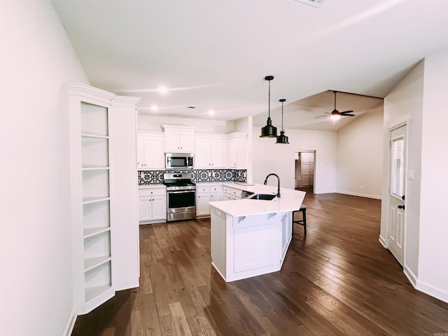 11 Shadow Creek Dr, Austin, AR 72007 - kitchen with appliances with stainless steel finishes, a sink, dark wood finished floors, white cabinets, and a breakfast bar area