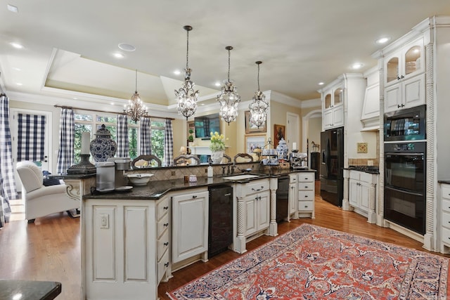 4 Dressage Ct, Little Rock, AR 72223 - kitchen with black appliances, a sink, ornamental molding, a chandelier, and wood finished floors