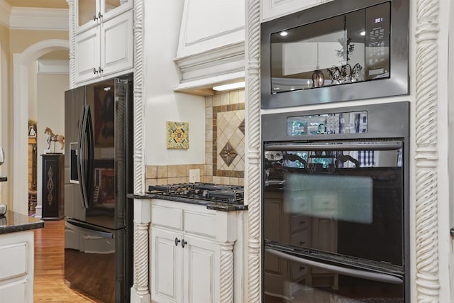4 Dressage Ct, Little Rock, AR 72223 - kitchen with black appliances, ornamental molding, light wood-style flooring, arched walkways, and white cabinets