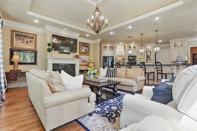 4 Dressage Ct, Little Rock, AR 72223 - living room featuring a chandelier, recessed lighting, a fireplace, light wood-style floors, and ornamental molding