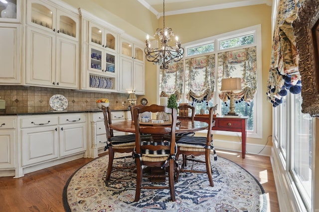 4 Dressage Ct, Little Rock, AR 72223 - dining area featuring dark wood-type flooring, ornamental molding, and a chandelier