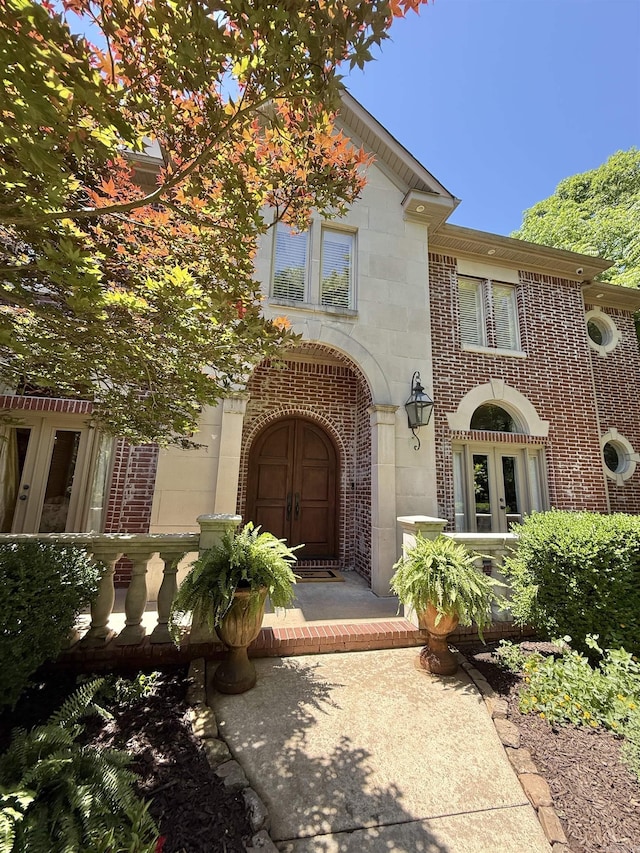 4 Dressage Ct, Little Rock, AR 72223 - view of front facade with french doors, brick siding, and stone siding