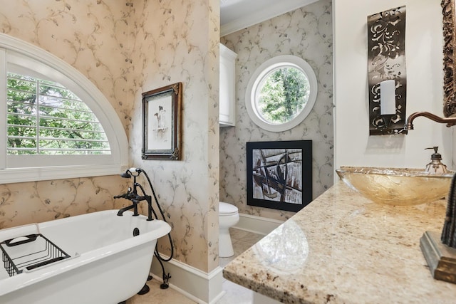 4 Dressage Ct, Little Rock, AR 72223 - bathroom featuring wallpapered walls, a freestanding bath, baseboards, toilet, and vanity