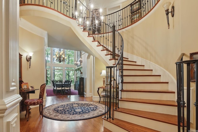 4 Dressage Ct, Little Rock, AR 72223 - entrance foyer featuring a towering ceiling, a chandelier, stairway, wood finished floors, and baseboards
