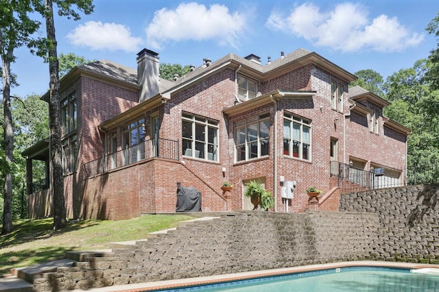 4 Dressage Ct, Little Rock, AR 72223 - rear view of house with brick siding, a chimney, and stairs