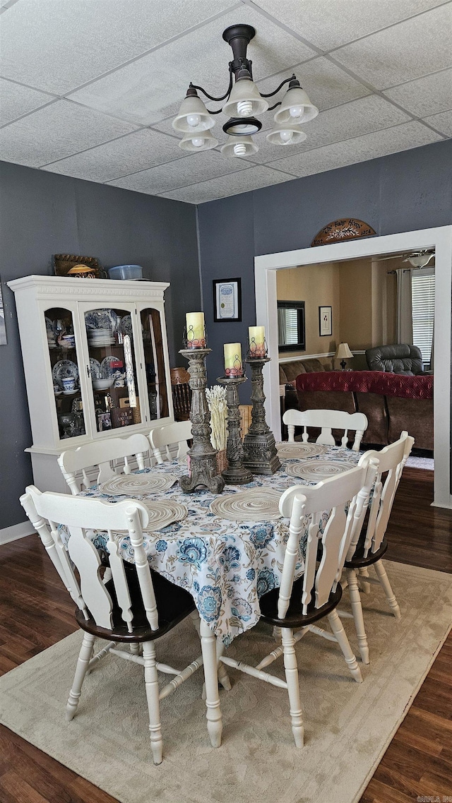 620 W 3rd St, Rector, AR 72461 - dining room featuring wood finished floors, a chandelier, and a paneled ceiling