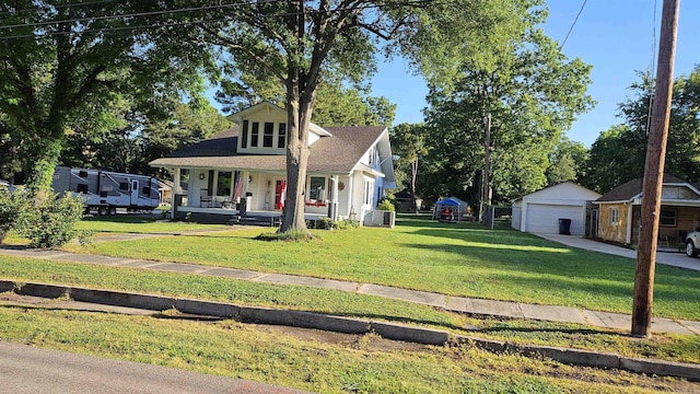 620 W 3rd St, Rector, AR 72461 - view of front of home with covered porch, a garage, a front yard, and an outdoor structure