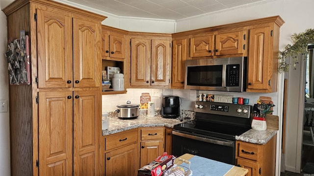 620 W 3rd St, Rector, AR 72461 - kitchen featuring stainless steel appliances, backsplash, light countertops, brown cabinets, and crown molding