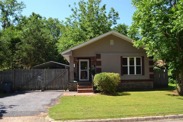 423 W Saint Louis St, Hot Springs, AR 71913 - view of front of house featuring brick siding, driveway, stucco siding, and a gate