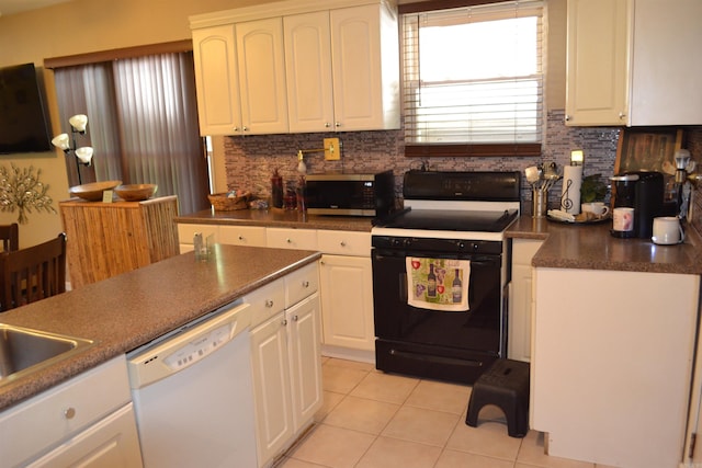 423 W Saint Louis St, Hot Springs, AR 71913 - kitchen featuring white dishwasher, black / electric stove, stainless steel microwave, light tile patterned flooring, and decorative backsplash
