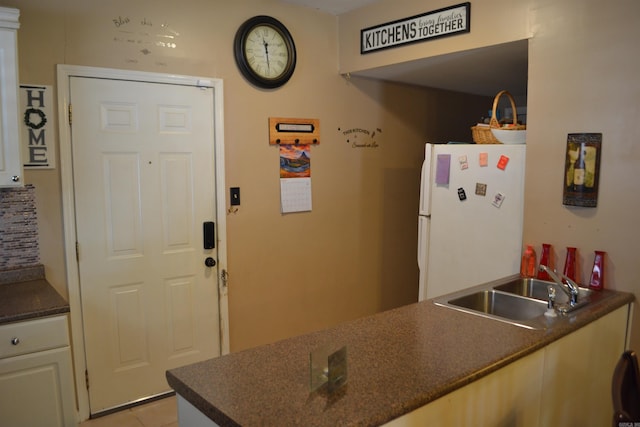 423 W Saint Louis St, Hot Springs, AR 71913 - kitchen featuring freestanding refrigerator, a sink, dark countertops, and light tile patterned floors