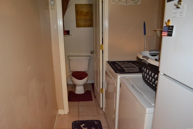 423 W Saint Louis St, Hot Springs, AR 71913 - washroom featuring washer and dryer, light tile patterned flooring, and baseboards