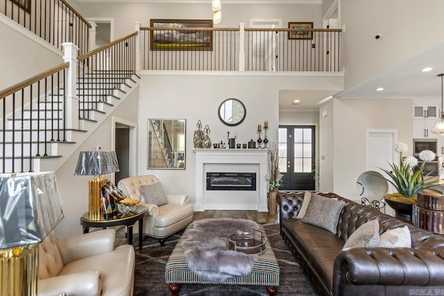 6020 Centark Ct, Alexander, AR 72002 - living area featuring a towering ceiling, stairway, a glass covered fireplace, and recessed lighting