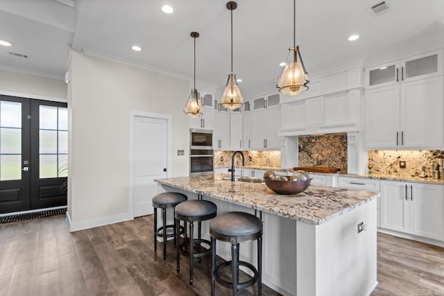 6020 Centark Ct, Alexander, AR 72002 - kitchen with appliances with stainless steel finishes, french doors, a sink, ornamental molding, and an island with sink