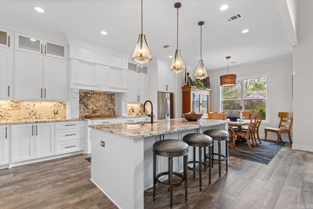 6020 Centark Ct, Alexander, AR 72002 - kitchen with stainless steel fridge, a sink, dark wood-style flooring, an island with sink, and recessed lighting