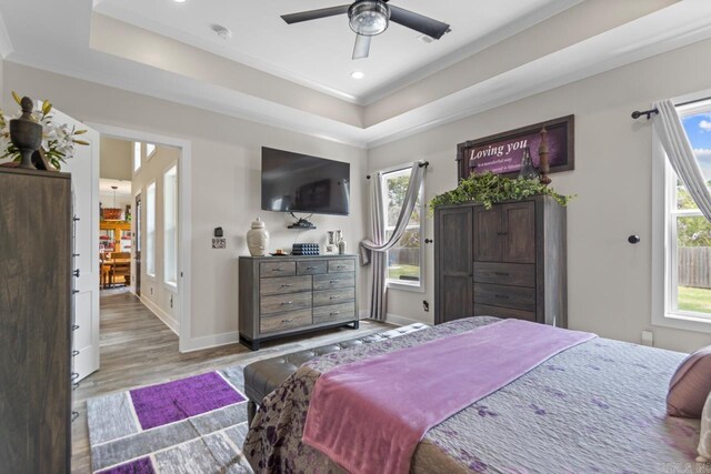 6020 Centark Ct, Alexander, AR 72002 - bedroom with multiple windows, a raised ceiling, wood finished floors, recessed lighting, and crown molding