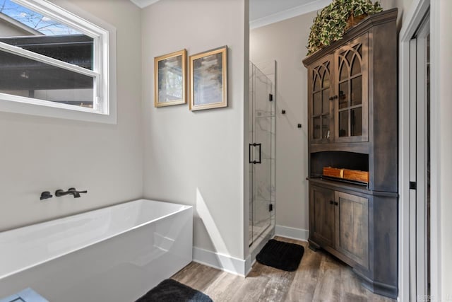6020 Centark Ct, Alexander, AR 72002 - full bath with a stall shower, wood finished floors, a bath, and baseboards