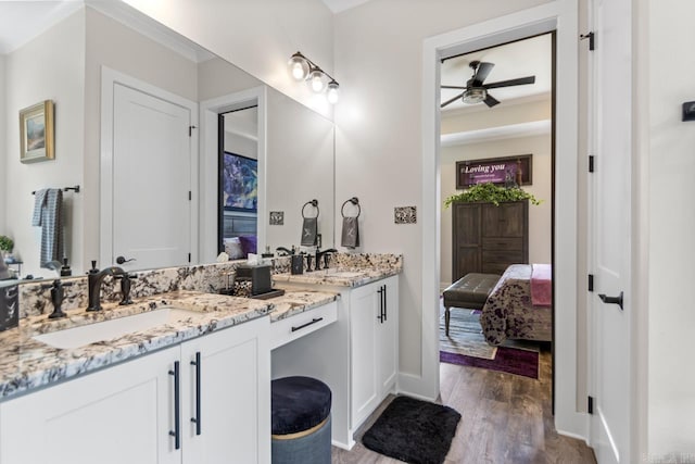 6020 Centark Ct, Alexander, AR 72002 - full bathroom with ensuite bathroom, wood finished floors, double vanity, a ceiling fan, and baseboards