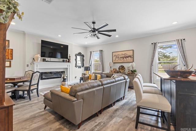 6020 Centark Ct, Alexander, AR 72002 - living room featuring light wood-style flooring, a ceiling fan, recessed lighting, and a glass covered fireplace