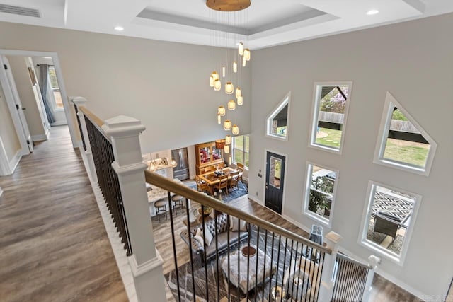 6020 Centark Ct, Alexander, AR 72002 - stairway featuring plenty of natural light, a tray ceiling, wood finished floors, a towering ceiling, and recessed lighting