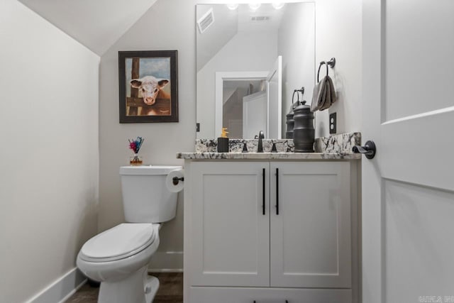 6020 Centark Ct, Alexander, AR 72002 - bathroom with vanity, toilet, baseboards, vaulted ceiling, and wood finished floors