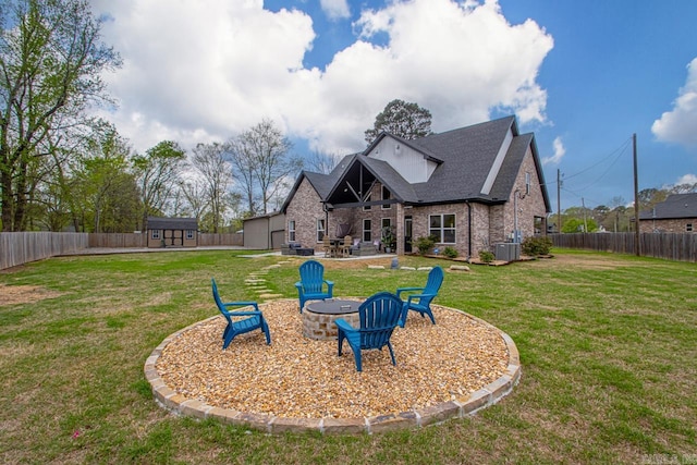 6020 Centark Ct, Alexander, AR 72002 - rear view of house with a fire pit, cooling unit, brick siding, a patio, and roof with shingles