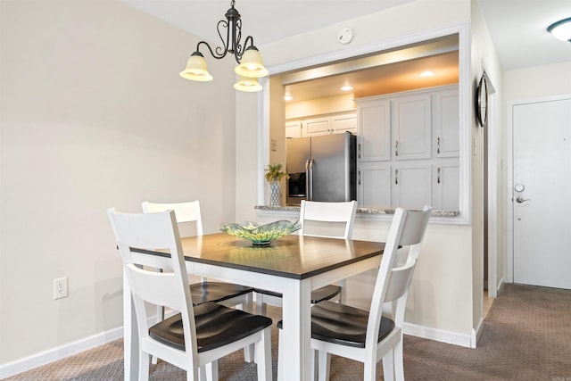 740 Weston Rd Unit 309-B, Hot Springs, AR 71913 - dining room featuring a chandelier, carpet flooring, and baseboards