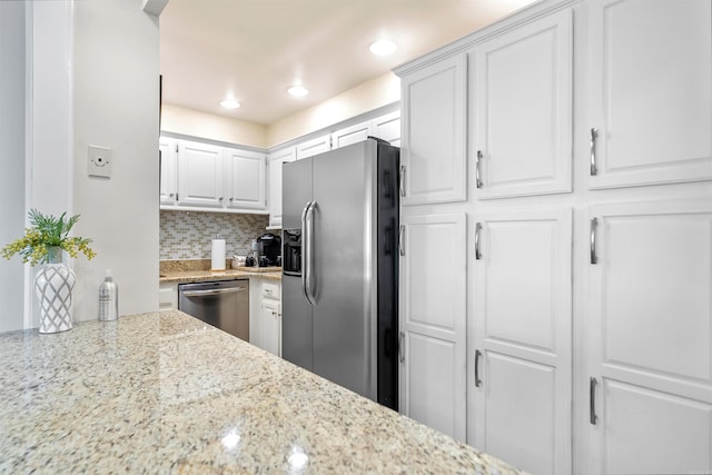 740 Weston Rd Unit 309-B, Hot Springs, AR 71913 - kitchen with appliances with stainless steel finishes, white cabinets, decorative backsplash, light stone counters, and recessed lighting