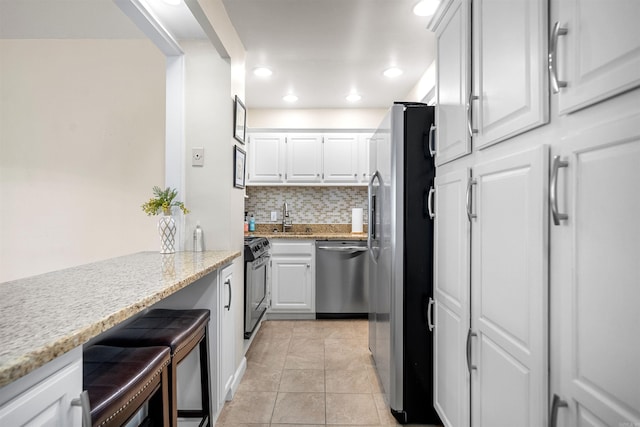 740 Weston Rd Unit 309-B, Hot Springs, AR 71913 - kitchen with stainless steel appliances, backsplash, a sink, recessed lighting, and white cabinets