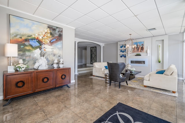 740 Weston Rd Unit 309-B, Hot Springs, AR 71913 - living room featuring arched walkways, a chandelier, baseboards, and a drop ceiling