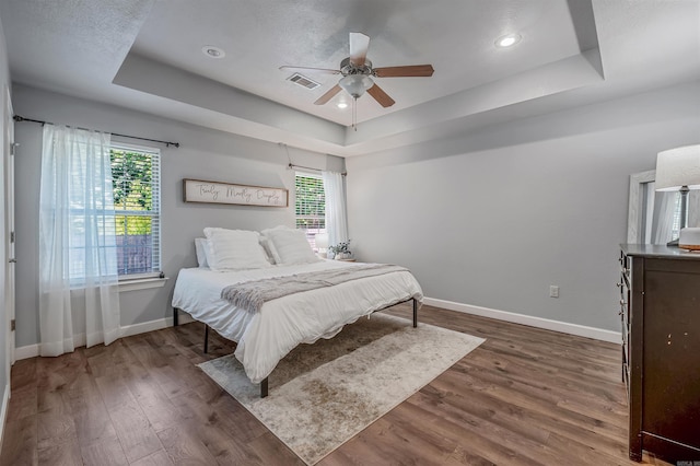58 Eaglebrook Dr, Conway, AR 72032 - bedroom featuring a raised ceiling, baseboards, wood finished floors, ceiling fan, and recessed lighting