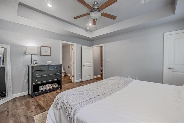 58 Eaglebrook Dr, Conway, AR 72032 - bedroom with a raised ceiling, wood finished floors, baseboards, and recessed lighting