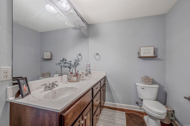 58 Eaglebrook Dr, Conway, AR 72032 - bathroom featuring double vanity, toilet, and baseboards