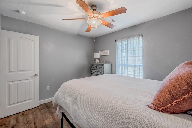 58 Eaglebrook Dr, Conway, AR 72032 - bedroom featuring wood finished floors, baseboards, ceiling fan, and a textured wall
