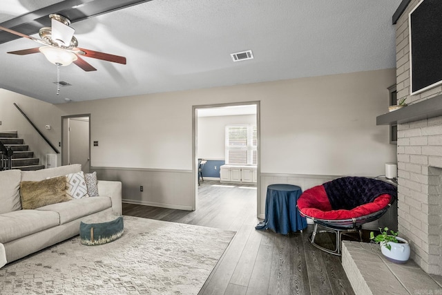 2 Timber Ridge Ct, Little Rock, AR 72211 - living area featuring wood finished floors, a ceiling fan, wainscoting, a brick fireplace, and stairway