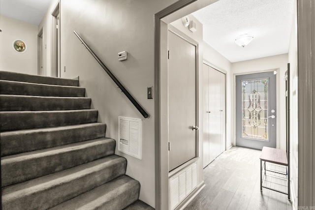 2 Timber Ridge Ct, Little Rock, AR 72211 - stairs featuring wood finished floors and a textured ceiling