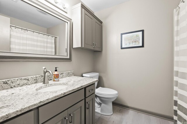 2 Timber Ridge Ct, Little Rock, AR 72211 - bathroom with vanity, toilet, wood finished floors, and baseboards