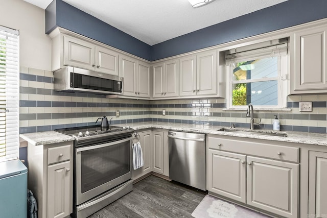2 Timber Ridge Ct, Little Rock, AR 72211 - kitchen featuring stainless steel appliances, a sink, dark wood-style flooring, tasteful backsplash, and a textured ceiling