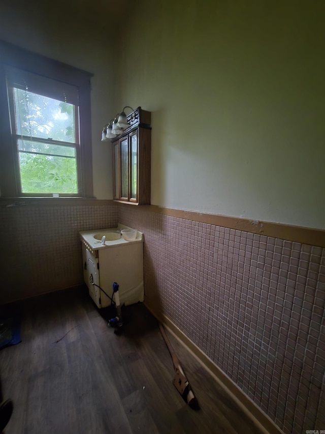 1609 W Charles Bussey Ave, Little Rock, AR 72202 - bathroom featuring tile walls, wainscoting, wood finished floors, and vanity