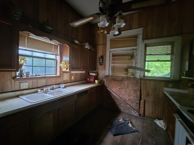1609 W Charles Bussey Ave, Little Rock, AR 72202 - kitchen featuring a sink, wood walls, a ceiling fan, light countertops, and wood finished floors