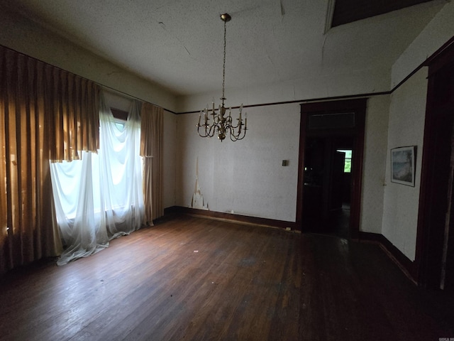 1609 W Charles Bussey Ave, Little Rock, AR 72202 - unfurnished dining area with a chandelier, wood finished floors, and baseboards