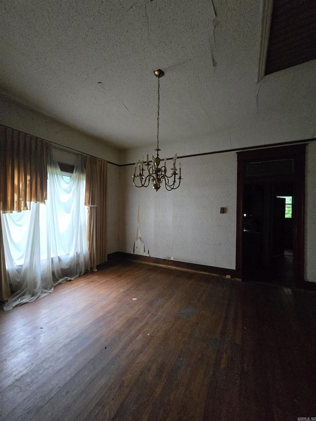 1609 W Charles Bussey Ave, Little Rock, AR 72202 - unfurnished dining area with a chandelier, wood finished floors, and a textured ceiling
