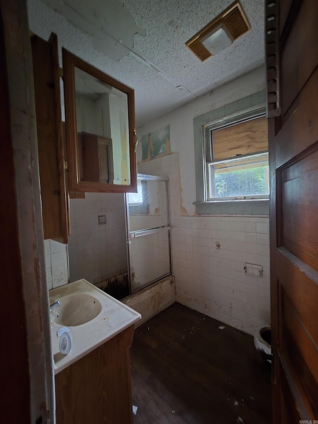 1609 W Charles Bussey Ave, Little Rock, AR 72202 - bathroom featuring tile walls, vanity, wood finished floors, and toilet